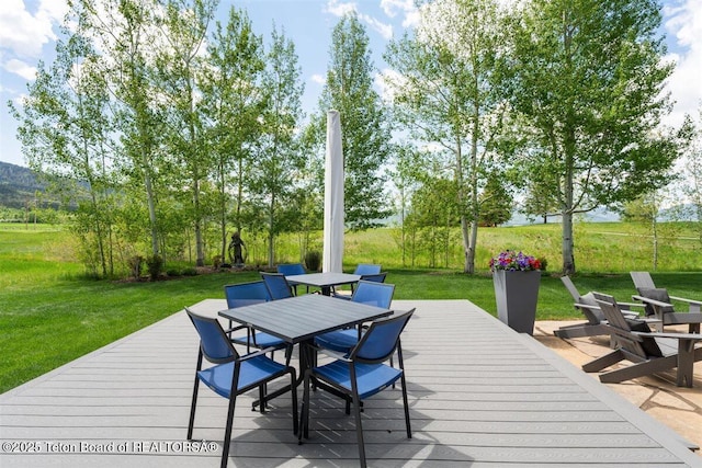 62 Hastings Dr, Victor, ID 83455 - deck featuring outdoor dining space and a lawn