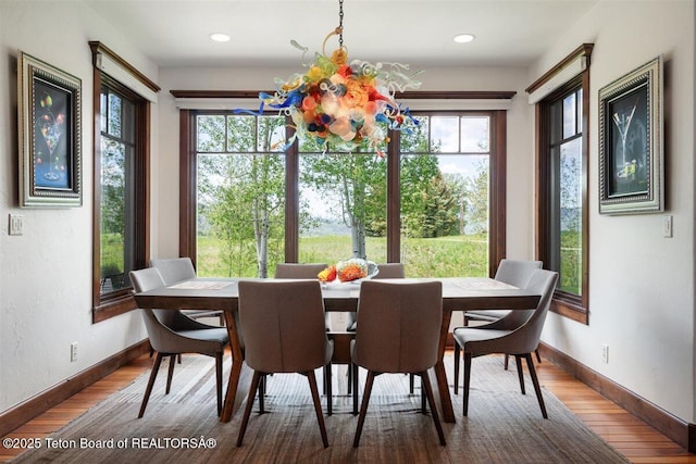 62 Hastings Dr, Victor, ID 83455 - dining room featuring healthy amount of natural light, baseboards, wood finished floors, a chandelier, and recessed lighting