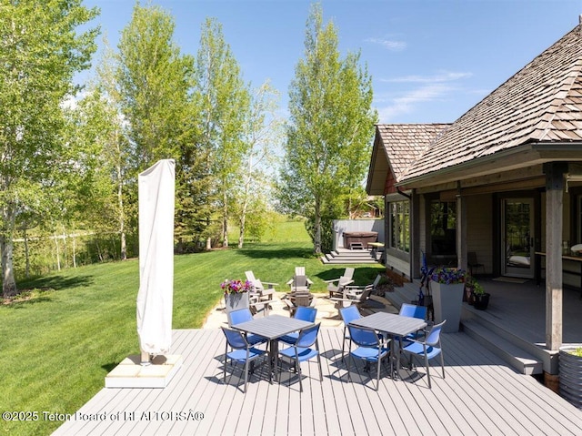 62 Hastings Dr, Victor, ID 83455 - wooden terrace with outdoor dining area and a yard