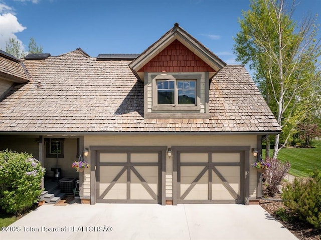 62 Hastings Dr, Victor, ID 83455 - garage featuring concrete driveway and central air condition unit