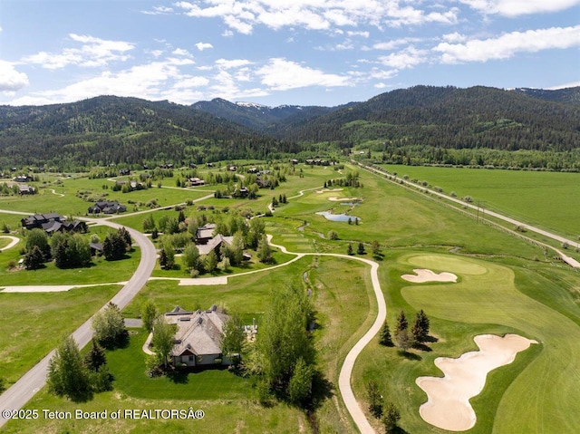 62 Hastings Dr, Victor, ID 83455 - aerial view of a mountain backdrop, a heavily wooded area, and a local golf course