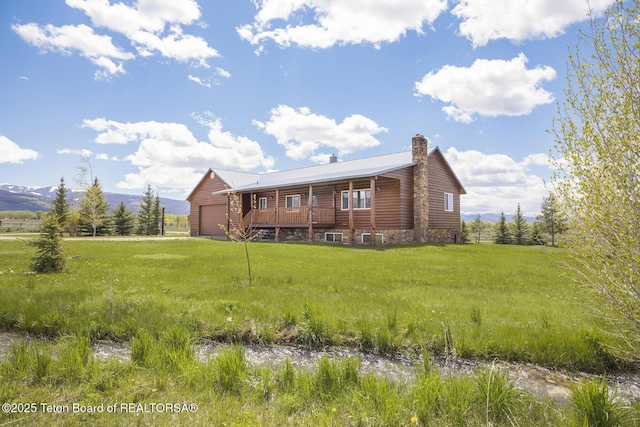 188 E 3000 S, Driggs, ID 83422 - back of property featuring a chimney, a garage, and metal roof