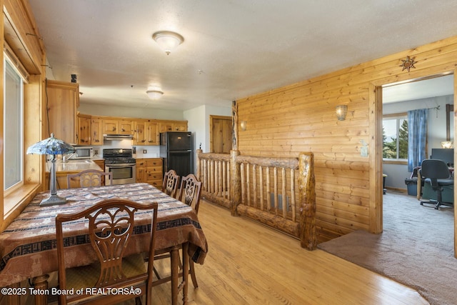 188 E 3000 S, Driggs, ID 83422 - dining area with light wood-style floors and wooden walls