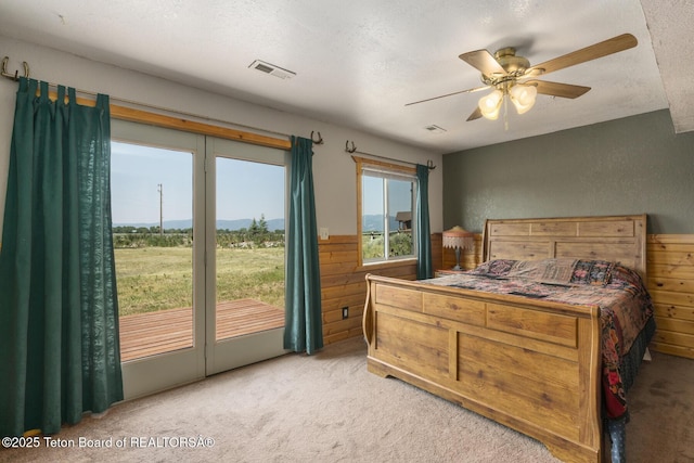 188 E 3000 S, Driggs, ID 83422 - bedroom featuring carpet floors, a textured ceiling, wood walls, a ceiling fan, and access to outside