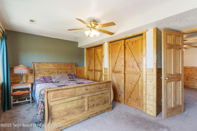 188 E 3000 S, Driggs, ID 83422 - bedroom featuring carpet, wooden walls, a wainscoted wall, and ceiling fan