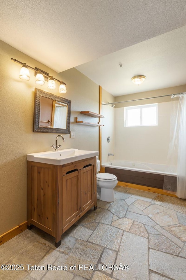 188 E 3000 S, Driggs, ID 83422 - full bath with vanity, shower / tub combo, stone tile flooring, toilet, and baseboards