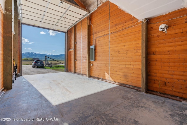 6827 S 1750 W, Victor, ID 83455 - garage featuring a mountain view, wood walls, and electric panel