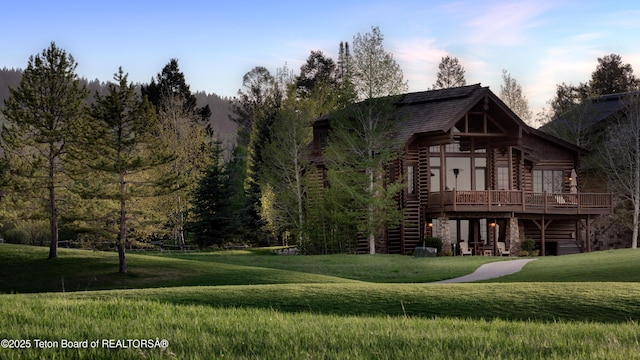 88 Blackfoot Trl, Victor, ID 83455 - cabin with a wooden deck, a front lawn, stairs, and log exterior