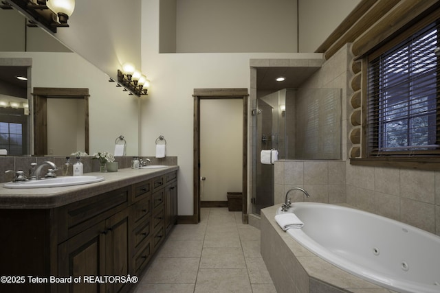 88 Blackfoot Trl, Victor, ID 83455 - bathroom featuring a tub with jets, double vanity, a stall shower, tile patterned floors, and baseboards