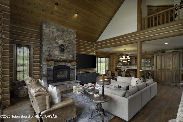 88 Blackfoot Trl, Victor, ID 83455 - living room featuring high vaulted ceiling, a chandelier, rustic walls, hardwood / wood-style flooring, and a fireplace