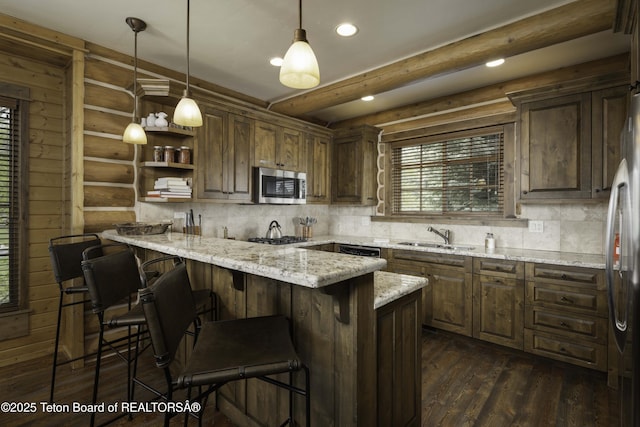 88 Blackfoot Trl, Victor, ID 83455 - kitchen featuring appliances with stainless steel finishes, recessed lighting, backsplash, a kitchen breakfast bar, and a sink