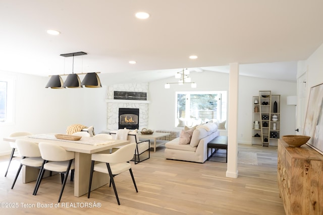 755 Cache Creek Dr, Jackson, WY 83001 - dining space featuring light wood-style floors, vaulted ceiling, a fireplace, baseboards, and recessed lighting