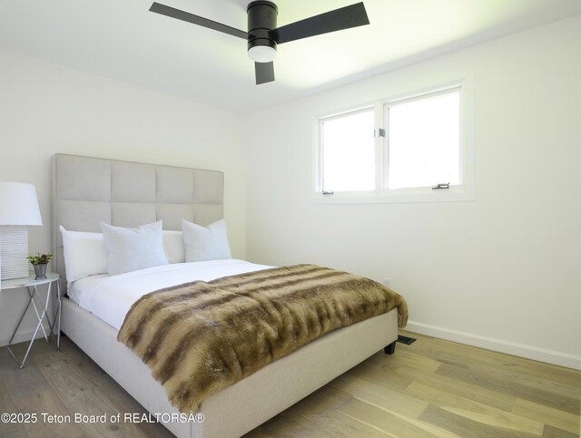 755 Cache Creek Dr, Jackson, WY 83001 - bedroom featuring wood finished floors, baseboards, and ceiling fan