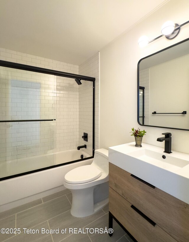 755 Cache Creek Dr, Jackson, WY 83001 - bathroom featuring vanity, combined bath / shower with glass door, toilet, and tile patterned flooring
