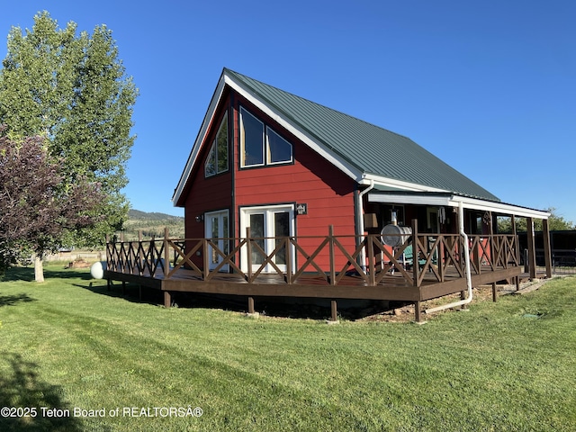 522 El Clark Ln, Smoot, WY 83126 - back of property featuring a lawn, a metal roof, and a deck