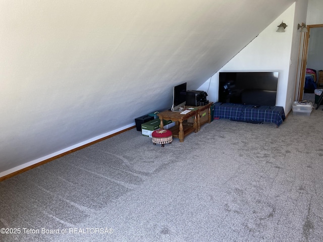 522 El Clark Ln, Smoot, WY 83126 - carpeted living room featuring vaulted ceiling and baseboards