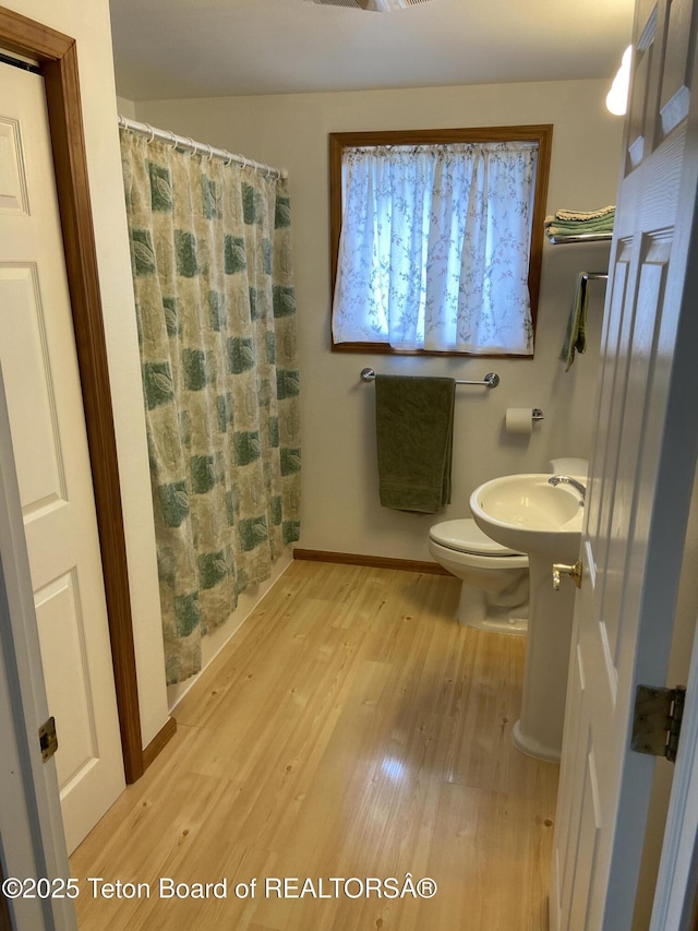 522 El Clark Ln, Smoot, WY 83126 - full bathroom with wood finished floors and a shower with shower curtain