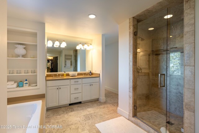 6960 Lupine Trl, Wilson, WY 83001 - bathroom with double vanity, a shower stall, a tub to relax in, baseboards, and built in shelves