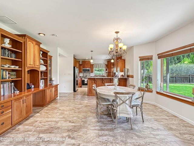 33 Wagon Rut Ln, Auburn, WY 83111 - dining area with a chandelier, baseboards, and stone finish floors