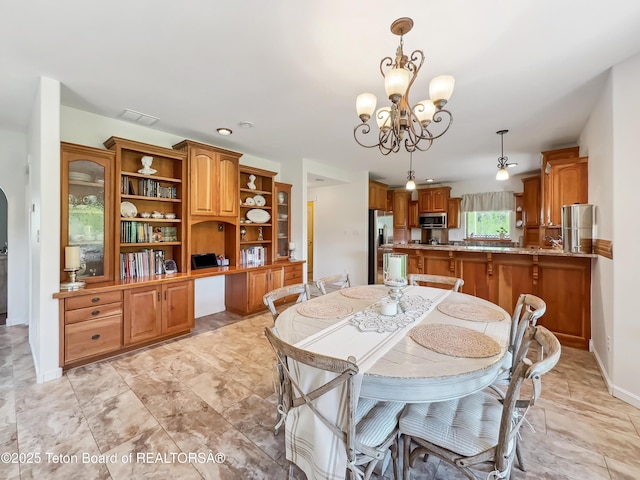 33 Wagon Rut Ln, Auburn, WY 83111 - dining area featuring a chandelier and baseboards