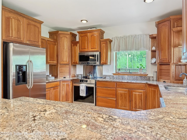 33 Wagon Rut Ln, Auburn, WY 83111 - kitchen featuring appliances with stainless steel finishes, a sink, light stone countertops, and open shelves