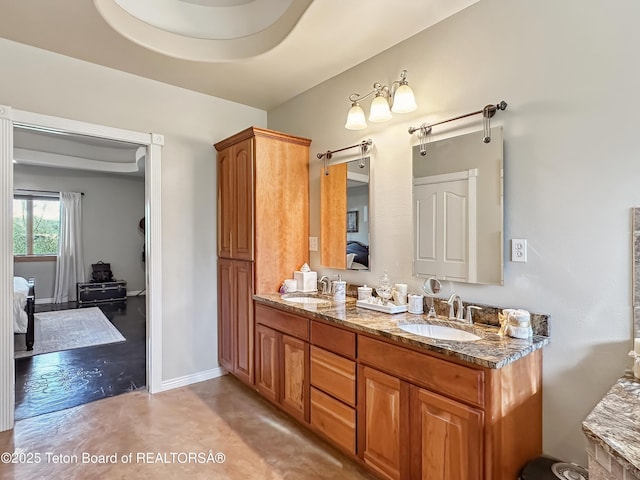 33 Wagon Rut Ln, Auburn, WY 83111 - ensuite bathroom with double vanity, finished concrete floors, and baseboards