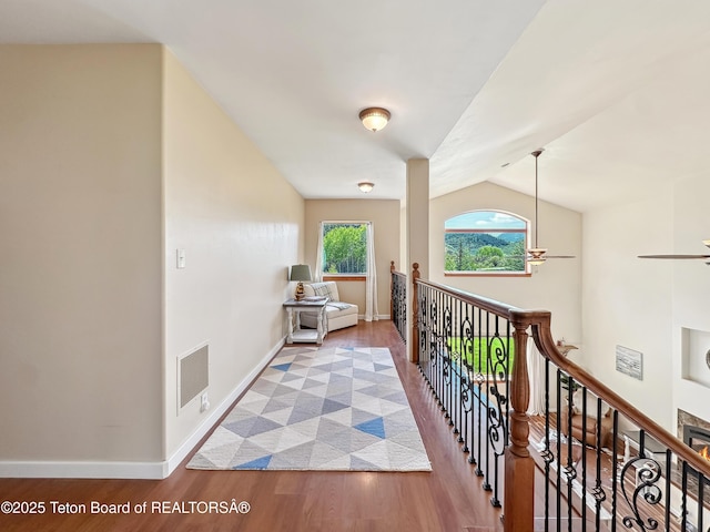 33 Wagon Rut Ln, Auburn, WY 83111 - hallway with wood finished floors, an upstairs landing, baseboards, and vaulted ceiling