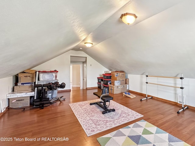 33 Wagon Rut Ln, Auburn, WY 83111 - workout area featuring wood finished floors, vaulted ceiling, and baseboards