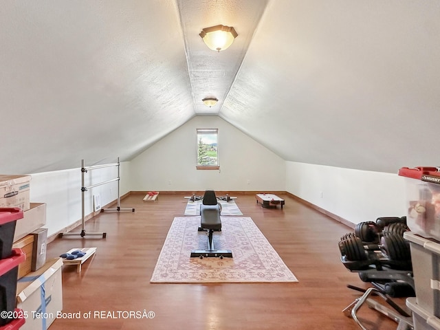 33 Wagon Rut Ln, Auburn, WY 83111 - workout area with wood finished floors, vaulted ceiling, and baseboards