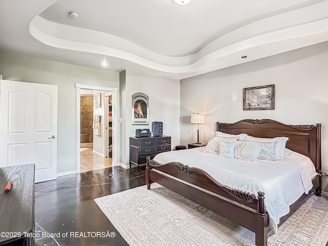 33 Wagon Rut Ln, Auburn, WY 83111 - bedroom with baseboards, finished concrete flooring, and a tray ceiling