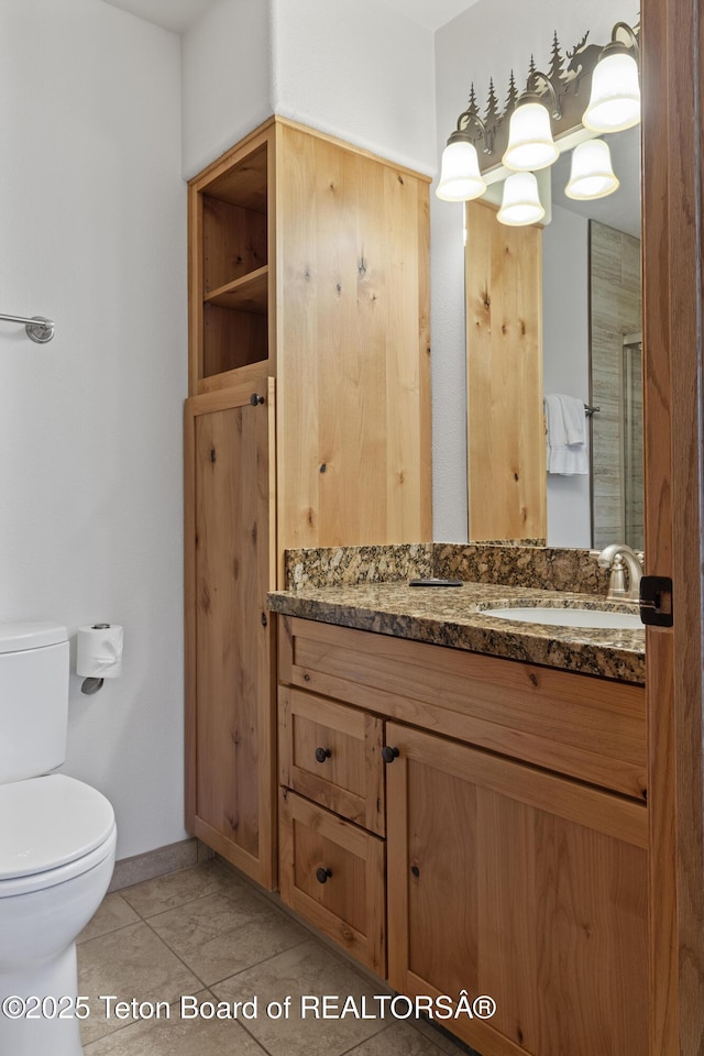 371 Snow King Loop, Jackson, WY 83001 - bathroom featuring vanity, toilet, tile patterned flooring, and baseboards