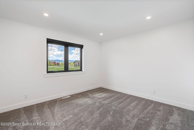 185 Columbine St, Alpine, WY 83128 - unfurnished room with dark carpet, recessed lighting, and baseboards