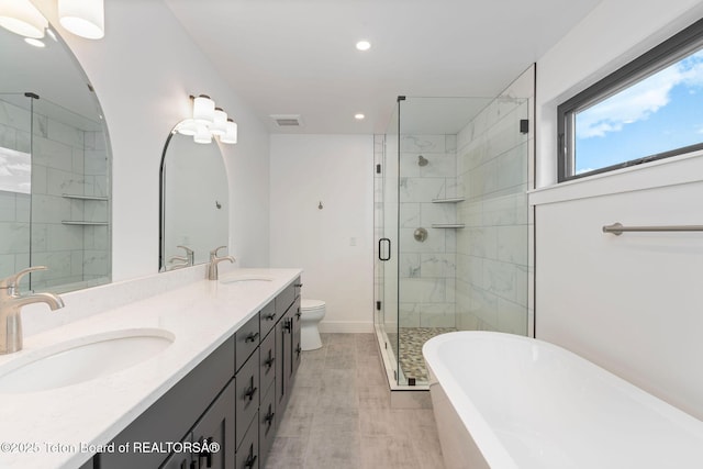 185 Columbine St, Alpine, WY 83128 - bathroom with a freestanding tub, a stall shower, double vanity, recessed lighting, and toilet