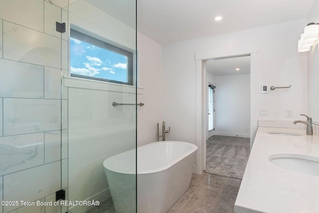 185 Columbine St, Alpine, WY 83128 - full bathroom featuring plenty of natural light, a soaking tub, double vanity, and recessed lighting