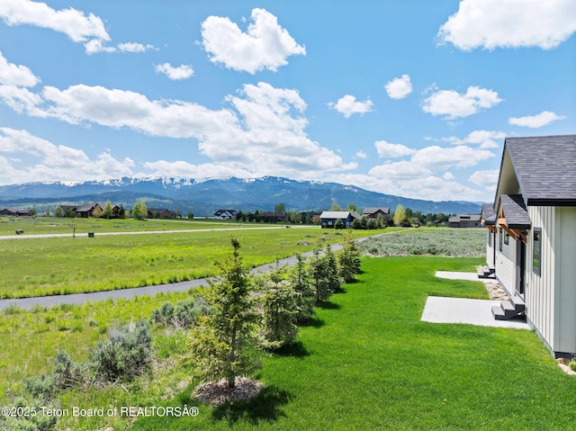 185 Columbine St, Alpine, WY 83128 - view of green lawn with a mountain view, a patio, and a view of countryside