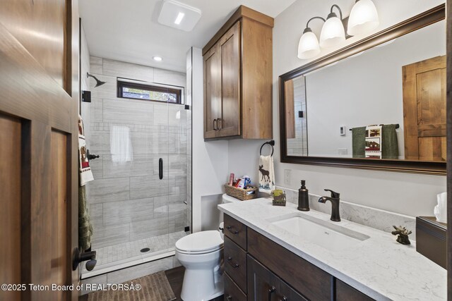 444 Riverview Dr, Alpine, WY 83128 - full bath with vanity, a stall shower, and toilet
