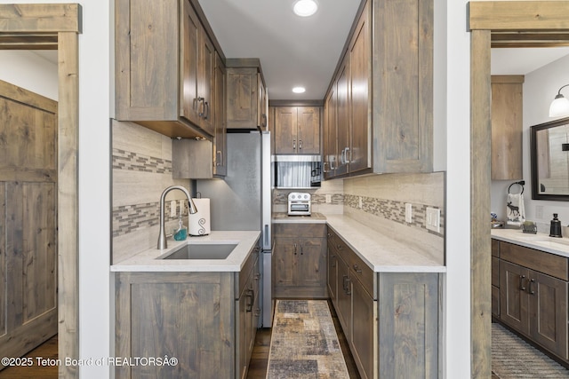 444 Riverview Dr, Alpine, WY 83128 - kitchen featuring a sink, backsplash, recessed lighting, and light countertops