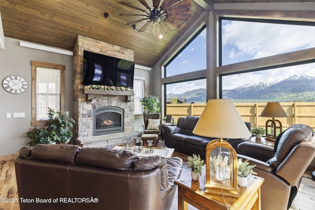 444 Riverview Dr, Alpine, WY 83128 - living room featuring wood finished floors, a fireplace, wood ceiling, high vaulted ceiling, and baseboards