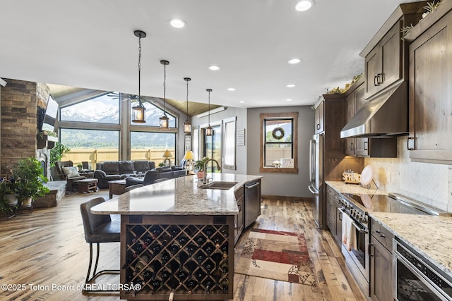 444 Riverview Dr, Alpine, WY 83128 - kitchen with stainless steel appliances, under cabinet range hood, light wood-style floors, a sink, and recessed lighting