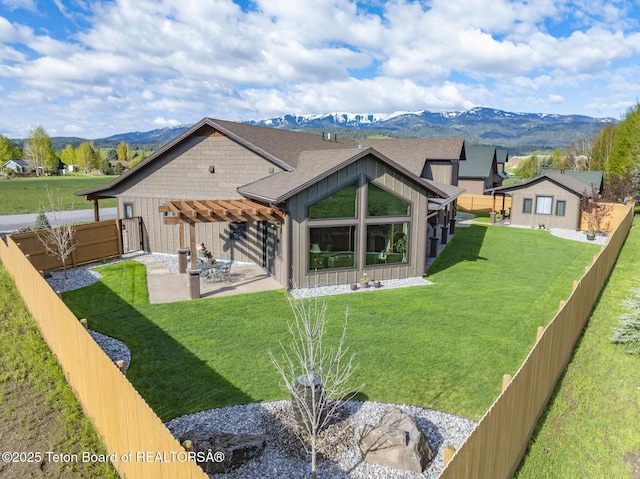 444 Riverview Dr, Alpine, WY 83128 - back of house with a mountain view, a pergola, a patio, and board and batten siding
