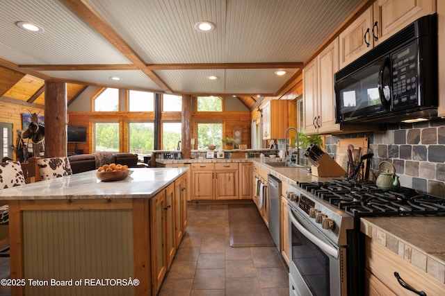 57 Lynx Trl, Alpine, WY 83128 - kitchen featuring stainless steel appliances, a sink, beam ceiling, backsplash, and open floor plan