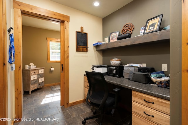 57 Lynx Trl, Alpine, WY 83128 - home office with baseboards, built in desk, dark stone finish flooring, and recessed lighting