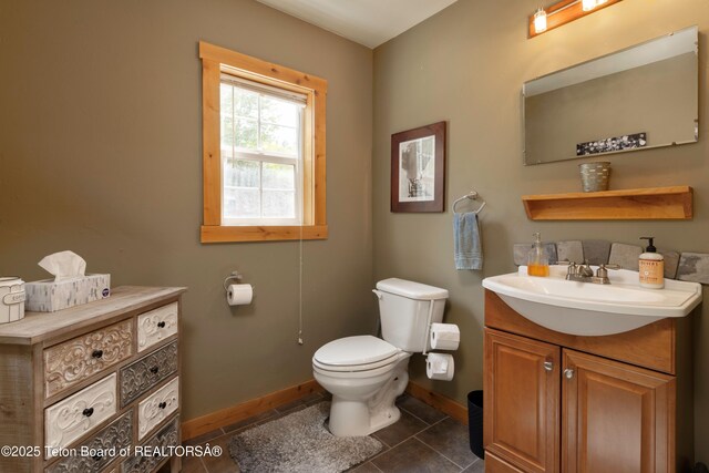 57 Lynx Trl, Alpine, WY 83128 - bathroom featuring baseboards, toilet, vanity, and tile patterned floors