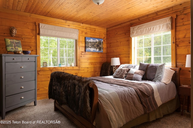 57 Lynx Trl, Alpine, WY 83128 - carpeted bedroom with multiple windows, wood walls, and wood ceiling