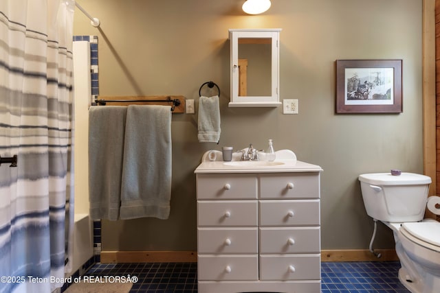 57 Lynx Trl, Alpine, WY 83128 - full bathroom featuring toilet, vanity, tile patterned floors, and baseboards