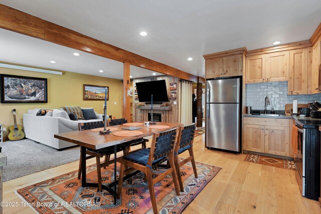 57 Lynx Trl, Alpine, WY 83128 - dining space with recessed lighting, light wood-style floors, beamed ceiling, and a fireplace