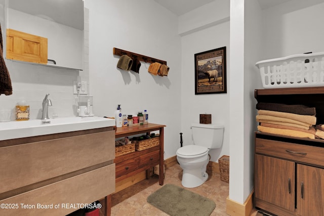 57 Lynx Trl, Alpine, WY 83128 - bathroom with vanity, toilet, and tasteful backsplash