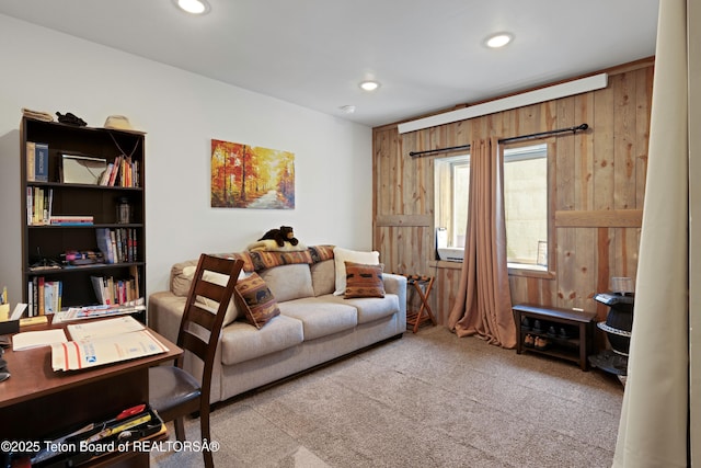 57 Lynx Trl, Alpine, WY 83128 - carpeted living area with recessed lighting, wood walls, and a desk