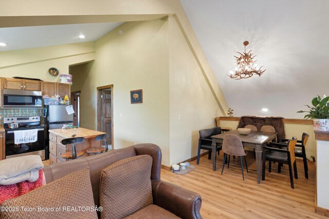 57 Lynx Trl, Alpine, WY 83128 - living room featuring light wood finished floors, high vaulted ceiling, a chandelier, recessed lighting, and baseboards