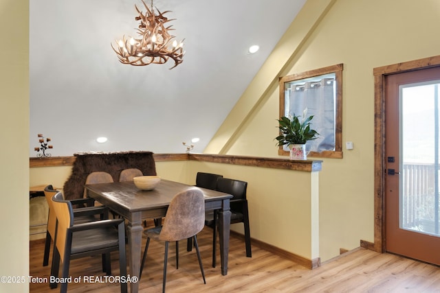 57 Lynx Trl, Alpine, WY 83128 - dining area with wood finished floors, a chandelier, vaulted ceiling, and recessed lighting
